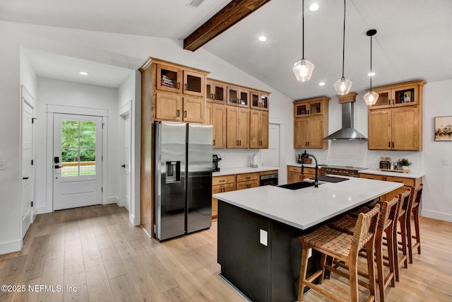kitchen featuring a sink, brown cabinets, stainless steel fridge with ice dispenser, light wood-style flooring, and wall chimney exhaust hood