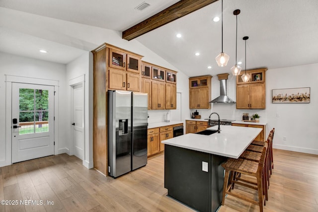 kitchen with recessed lighting, stainless steel fridge with ice dispenser, visible vents, wall chimney exhaust hood, and light wood-style flooring