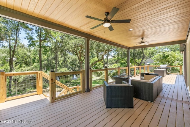 deck featuring outdoor lounge area and ceiling fan