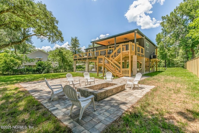 view of patio featuring a fire pit, stairway, ceiling fan, and a deck