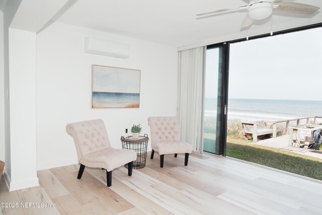 661 Ponte Vedra Blvd Unit 661B, Ponte Vedra Beach, FL 32082 - living area with wood finished floors, a water view, a wall mounted AC, a ceiling fan, and floor to ceiling windows