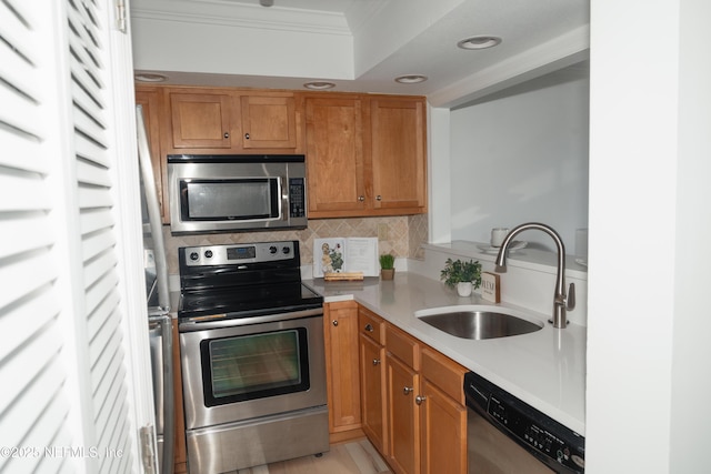 661 Ponte Vedra Blvd Unit 661B, Ponte Vedra Beach, FL 32082 - kitchen with appliances with stainless steel finishes, light countertops, backsplash, a sink, and crown molding