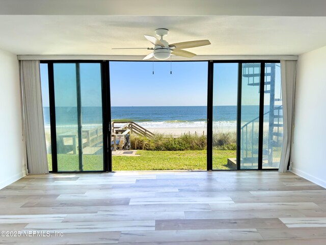 661 Ponte Vedra Blvd Unit 661B, Ponte Vedra Beach, FL 32082 - empty room featuring a ceiling fan, a water view, a wall of windows, and wood finished floors