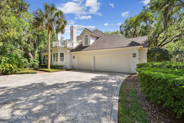 6230 Highlands Ct, Ponte Vedra Beach, FL 32082 - view of front of house with a balcony, a garage, concrete driveway, a chimney, and brick siding