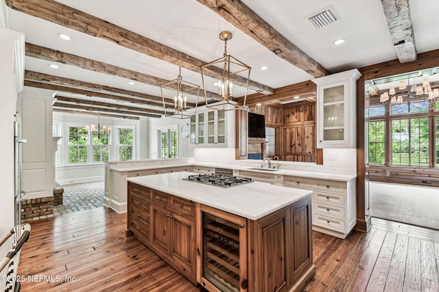 6230 Highlands Ct, Ponte Vedra Beach, FL 32082 - kitchen with a chandelier, wine cooler, light countertops, a peninsula, and dark wood-style floors