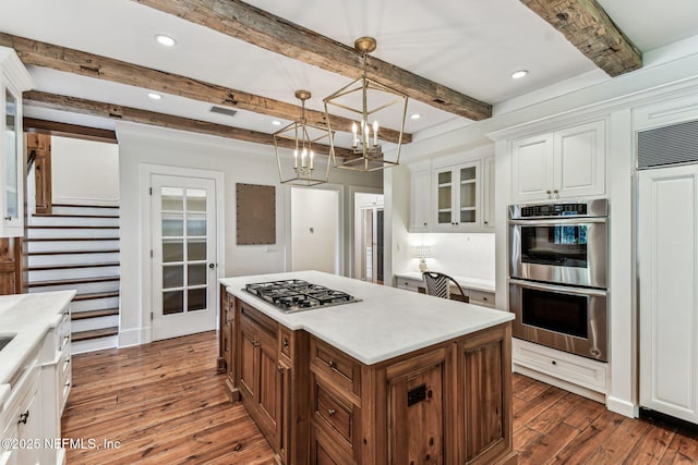 6230 Highlands Ct, Ponte Vedra Beach, FL 32082 - kitchen featuring stainless steel appliances, dark wood-type flooring, white cabinets, beam ceiling, and glass insert cabinets