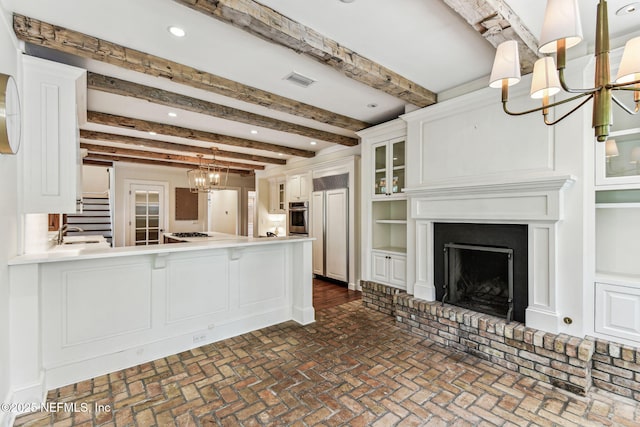 6230 Highlands Ct, Ponte Vedra Beach, FL 32082 - kitchen featuring a chandelier, oven, beamed ceiling, gas cooktop, and white cabinetry