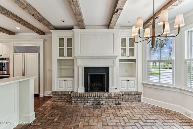 6230 Highlands Ct, Ponte Vedra Beach, FL 32082 - unfurnished living room featuring brick floors, baseboards, beam ceiling, a chandelier, and a brick fireplace