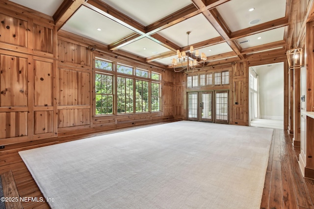 6230 Highlands Ct, Ponte Vedra Beach, FL 32082 - unfurnished living room featuring a chandelier, beamed ceiling, coffered ceiling, dark wood-style floors, and wooden walls