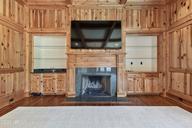 6230 Highlands Ct, Ponte Vedra Beach, FL 32082 - unfurnished living room with dark wood-type flooring, wooden walls, built in features, and a high end fireplace