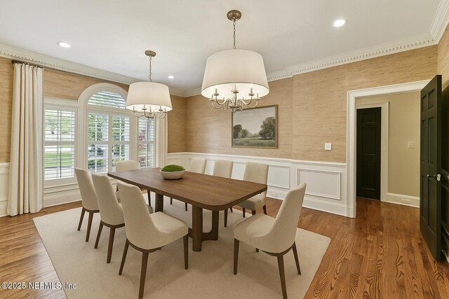 6230 Highlands Ct, Ponte Vedra Beach, FL 32082 - dining area featuring a chandelier, ornamental molding, a wainscoted wall, wood finished floors, and a decorative wall