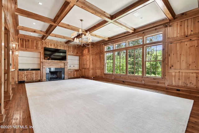 6230 Highlands Ct, Ponte Vedra Beach, FL 32082 - unfurnished living room with dark wood-style floors, wooden walls, beam ceiling, coffered ceiling, and a chandelier