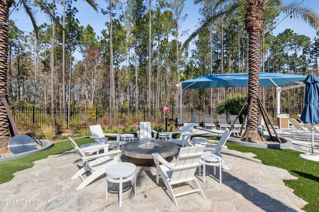 view of patio / terrace with fence and a fire pit