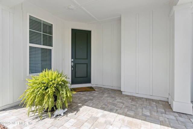 view of exterior entry featuring board and batten siding