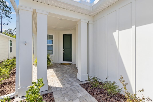 property entrance featuring board and batten siding