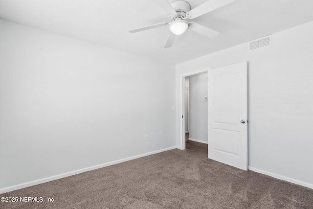 unfurnished bedroom with carpet floors, visible vents, a ceiling fan, and baseboards