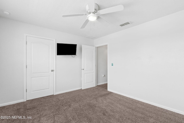 unfurnished bedroom featuring carpet, visible vents, a ceiling fan, and baseboards