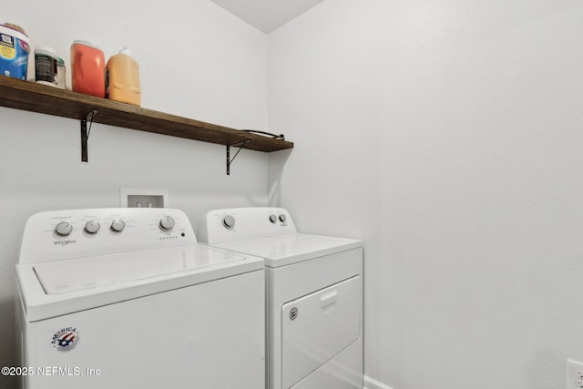 laundry area featuring washing machine and clothes dryer, baseboards, and laundry area