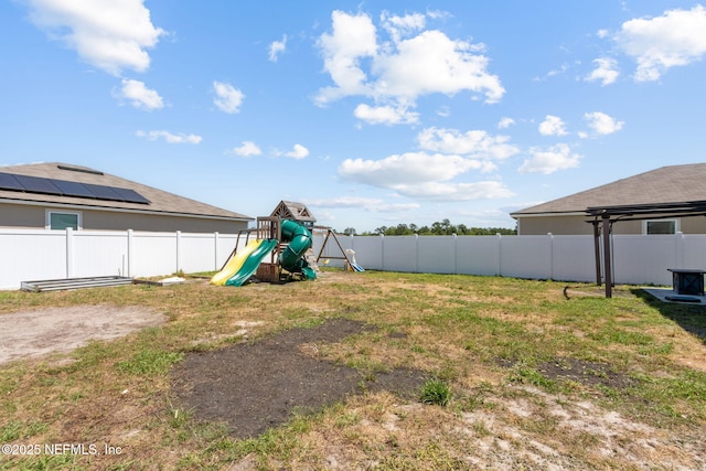 view of yard featuring a fenced backyard and a playground