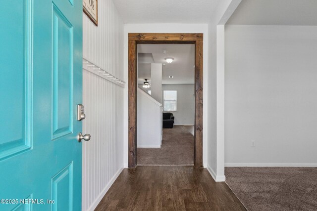 foyer entrance with baseboards and dark wood finished floors