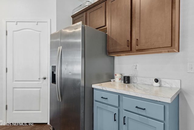 kitchen featuring light countertops and stainless steel fridge