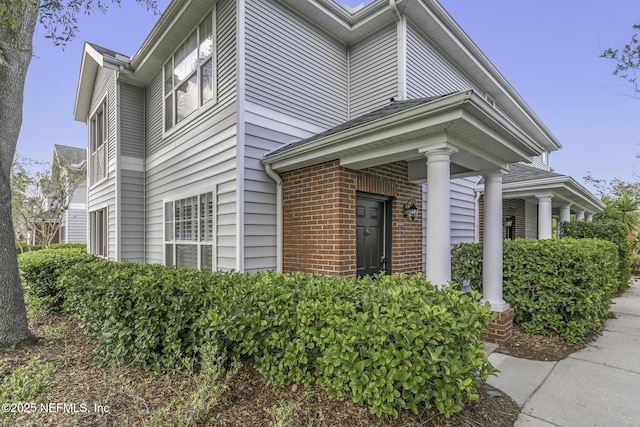 11213 Harbour Vista Cir, Saint Augustine, FL 32080 - view of side of property with brick siding and covered porch