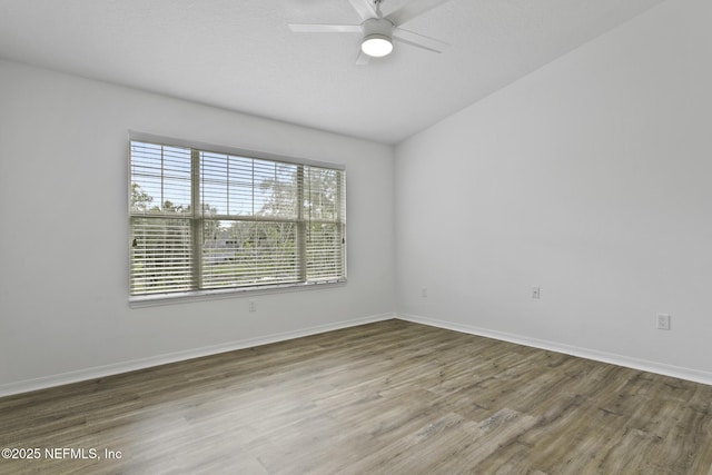 11213 Harbour Vista Cir, Saint Augustine, FL 32080 - empty room featuring baseboards, a ceiling fan, lofted ceiling, and wood finished floors