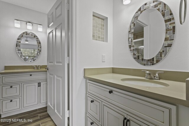 11213 Harbour Vista Cir, Saint Augustine, FL 32080 - bathroom featuring two vanities, a sink, and wood finished floors