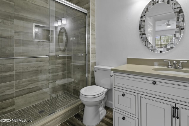 11213 Harbour Vista Cir, Saint Augustine, FL 32080 - bathroom with vanity, a stall shower, toilet, and wood finished floors