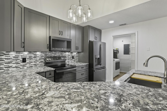 11213 Harbour Vista Cir, Saint Augustine, FL 32080 - kitchen with backsplash, electric range, washer / clothes dryer, a sink, and stainless steel fridge with ice dispenser