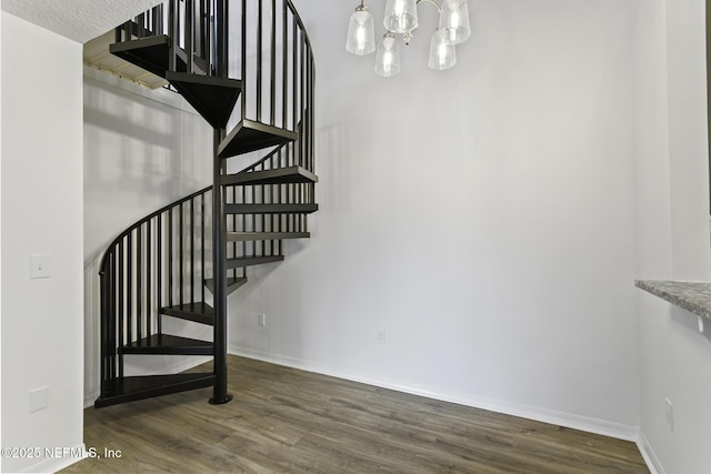 11213 Harbour Vista Cir, Saint Augustine, FL 32080 - stairway with baseboards, a chandelier, and wood finished floors