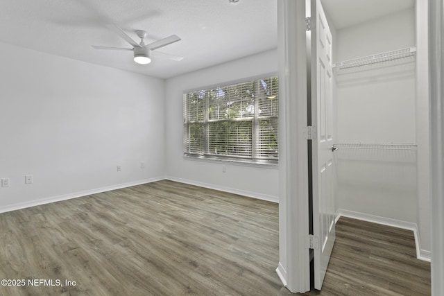 11213 Harbour Vista Cir, Saint Augustine, FL 32080 - unfurnished bedroom with a closet, baseboards, ceiling fan, and wood finished floors