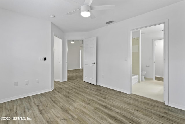 11213 Harbour Vista Cir, Saint Augustine, FL 32080 - unfurnished bedroom with baseboards, connected bathroom, wood finished floors, and visible vents