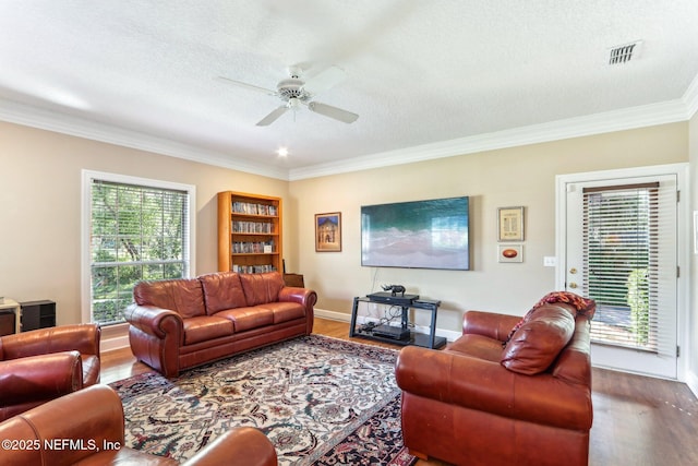 2942 Mandarin Hollow Dr, Jacksonville, FL 32257 - living room featuring a ceiling fan, ornamental molding, wood finished floors, and a healthy amount of sunlight