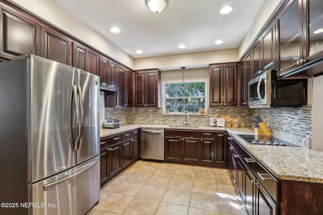 2942 Mandarin Hollow Dr, Jacksonville, FL 32257 - kitchen featuring tasteful backsplash, a sink, light stone counters, stainless steel appliances, and light tile patterned flooring