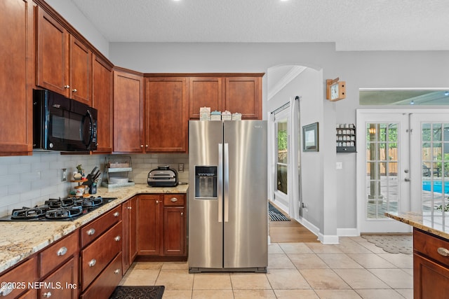 1712 Margarets Walk Rd, Fleming Island, FL 32003 - kitchen with light tile patterned floors, tasteful backsplash, and black appliances