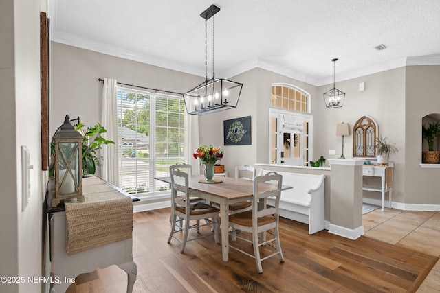 1712 Margarets Walk Rd, Fleming Island, FL 32003 - dining space featuring ornamental molding, wood finished floors, and a notable chandelier