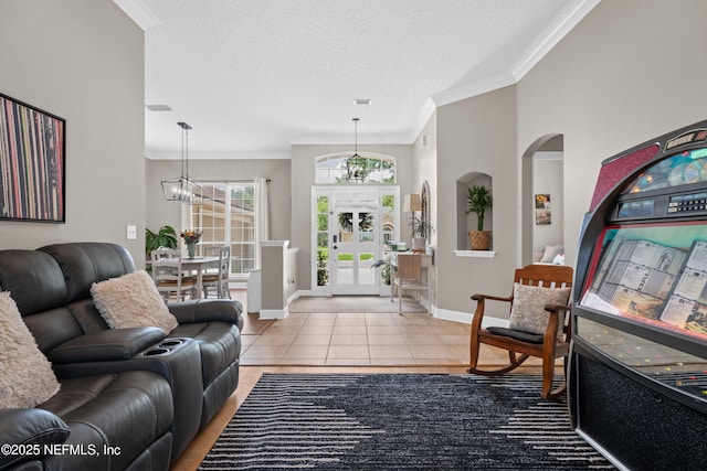 1712 Margarets Walk Rd, Fleming Island, FL 32003 - tiled living room featuring a textured ceiling, crown molding, arched walkways, baseboards, and a notable chandelier