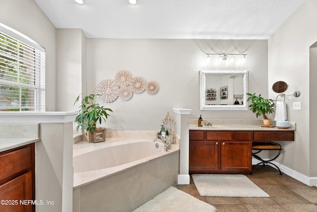 1712 Margarets Walk Rd, Fleming Island, FL 32003 - bathroom featuring vanity, baseboards, and a garden tub
