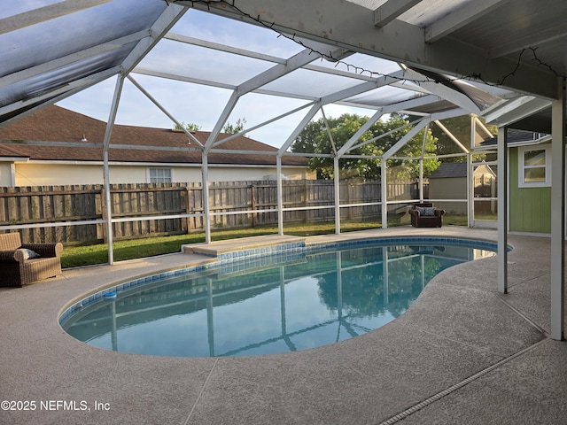 view of pool featuring a lanai, a fenced in pool, a patio area, and fence
