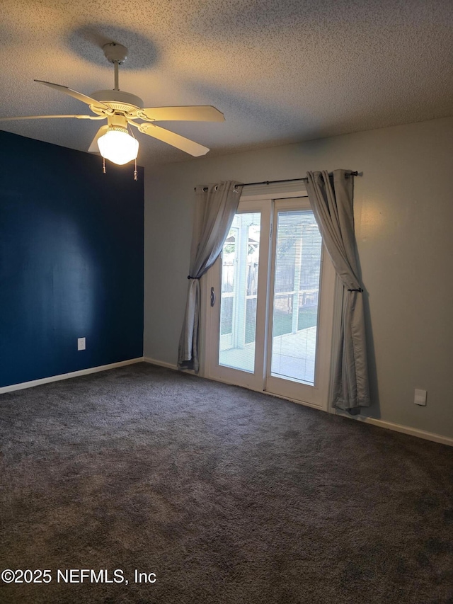 carpeted empty room featuring a textured ceiling, ceiling fan, and baseboards