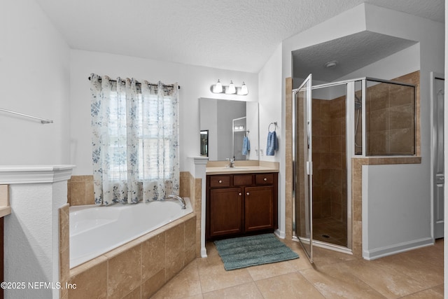 full bathroom with vanity, a textured ceiling, tile patterned floors, a bath, and a stall shower