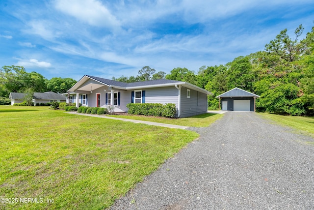 ranch-style home with a front lawn, an outdoor structure, and a detached garage