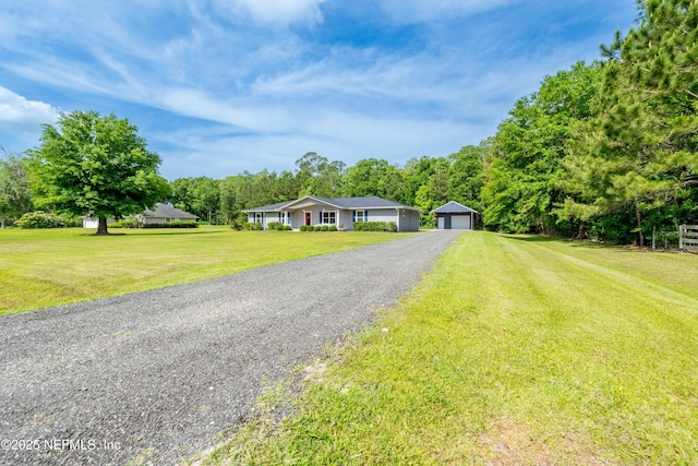 single story home featuring an outdoor structure, a front yard, and a garage