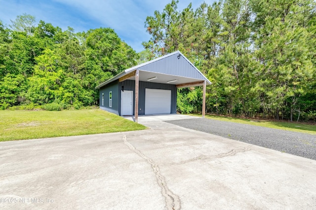 view of property exterior featuring an outdoor structure, aphalt driveway, a yard, and a detached garage