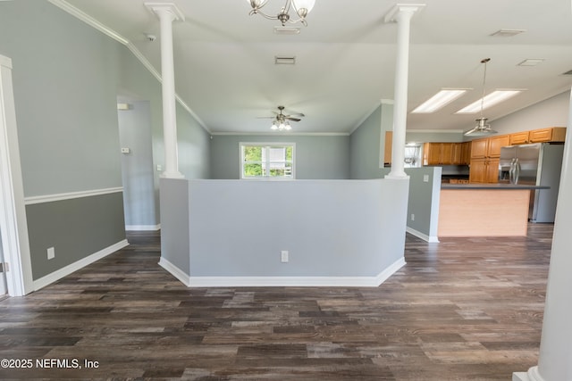 interior space with vaulted ceiling, dark wood-type flooring, and ornate columns