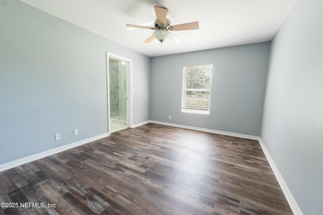 spare room with ceiling fan, baseboards, and dark wood-style floors