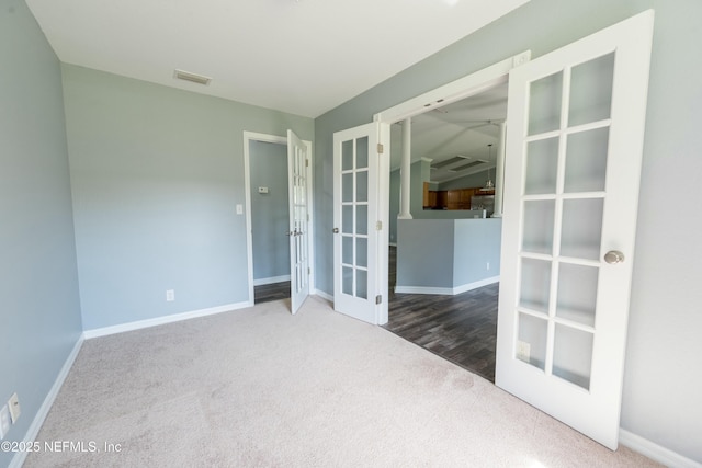empty room featuring baseboards, french doors, visible vents, and carpet
