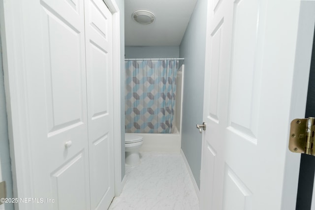 bathroom with shower / tub combo, baseboards, marble finish floor, and toilet
