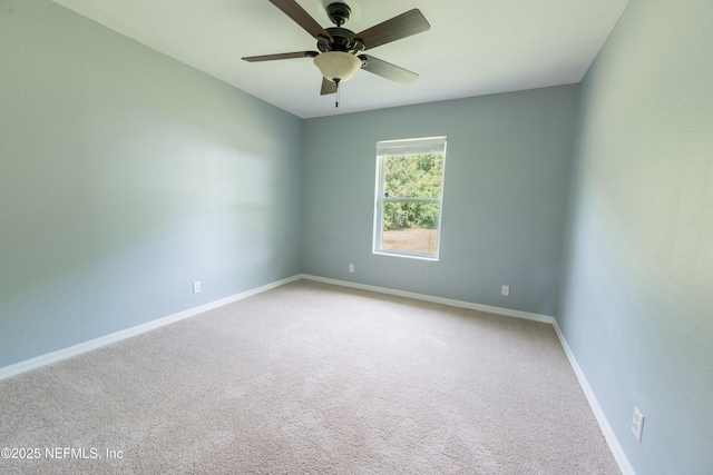 spare room with baseboards, a ceiling fan, and carpet flooring